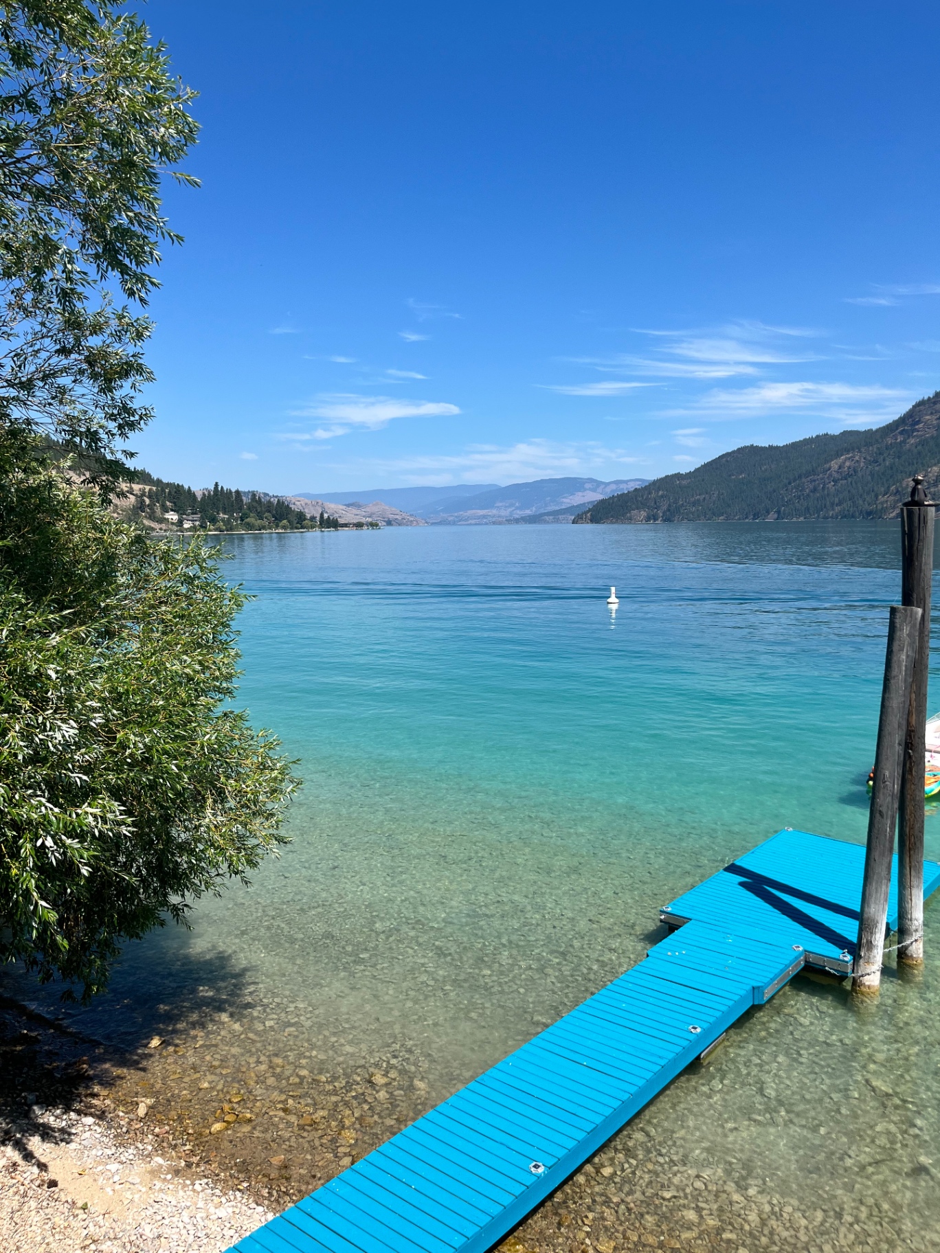 The clear turquoise calcite water of Kalamalka Lake beside a dock