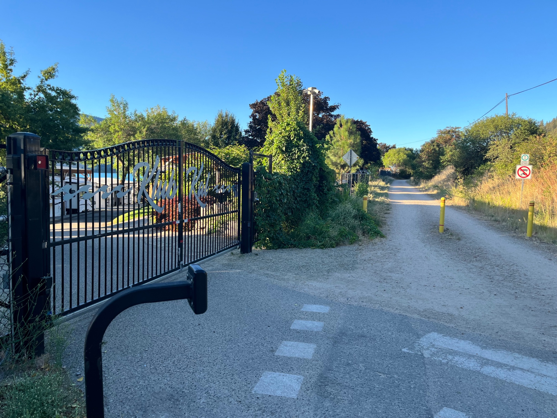 The gated Klub Kalamalka entrance beside the Okanagan Rail Trail