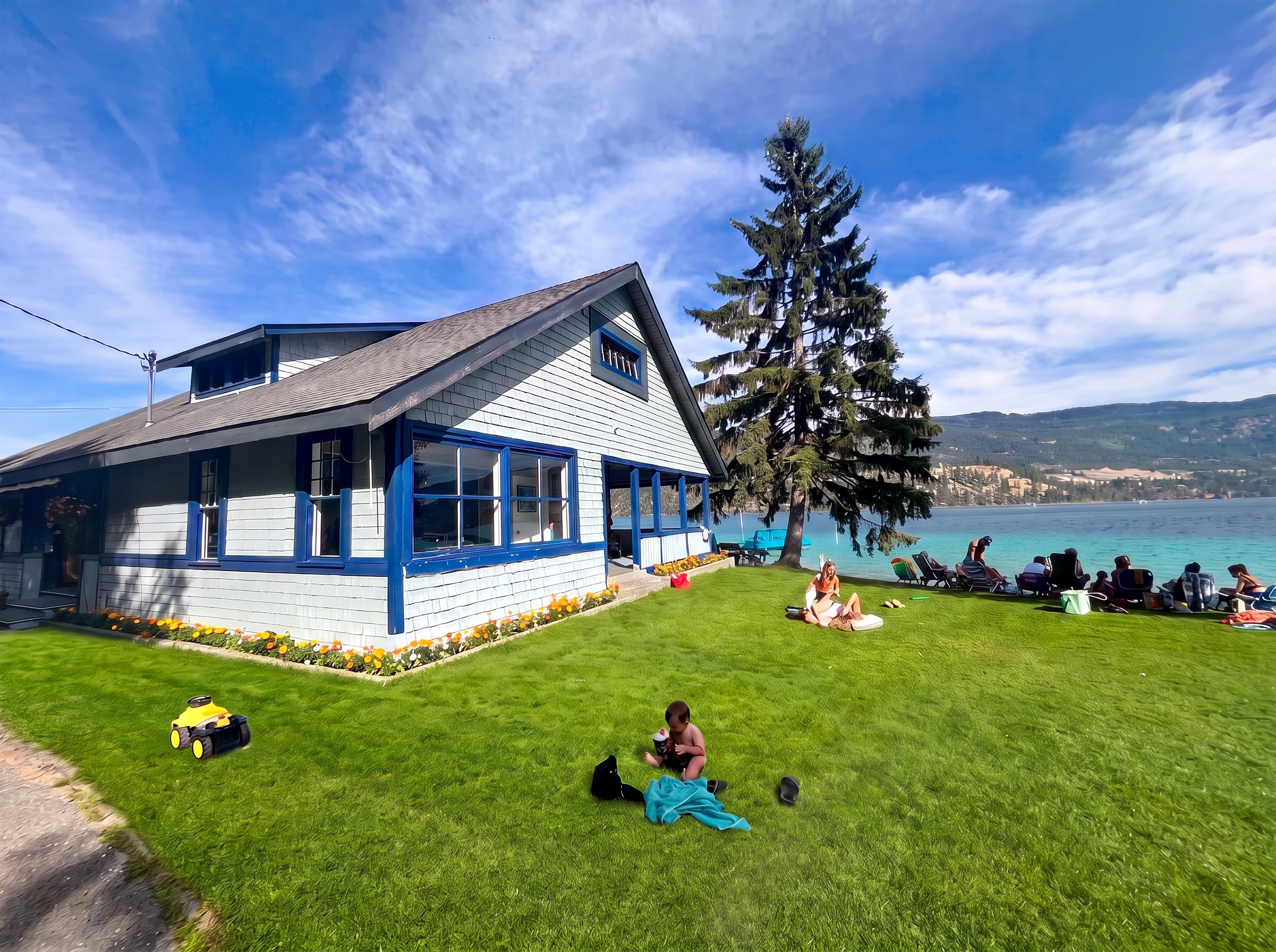 The historic blue clubhouse on the lawn beside Kalamalka Lake