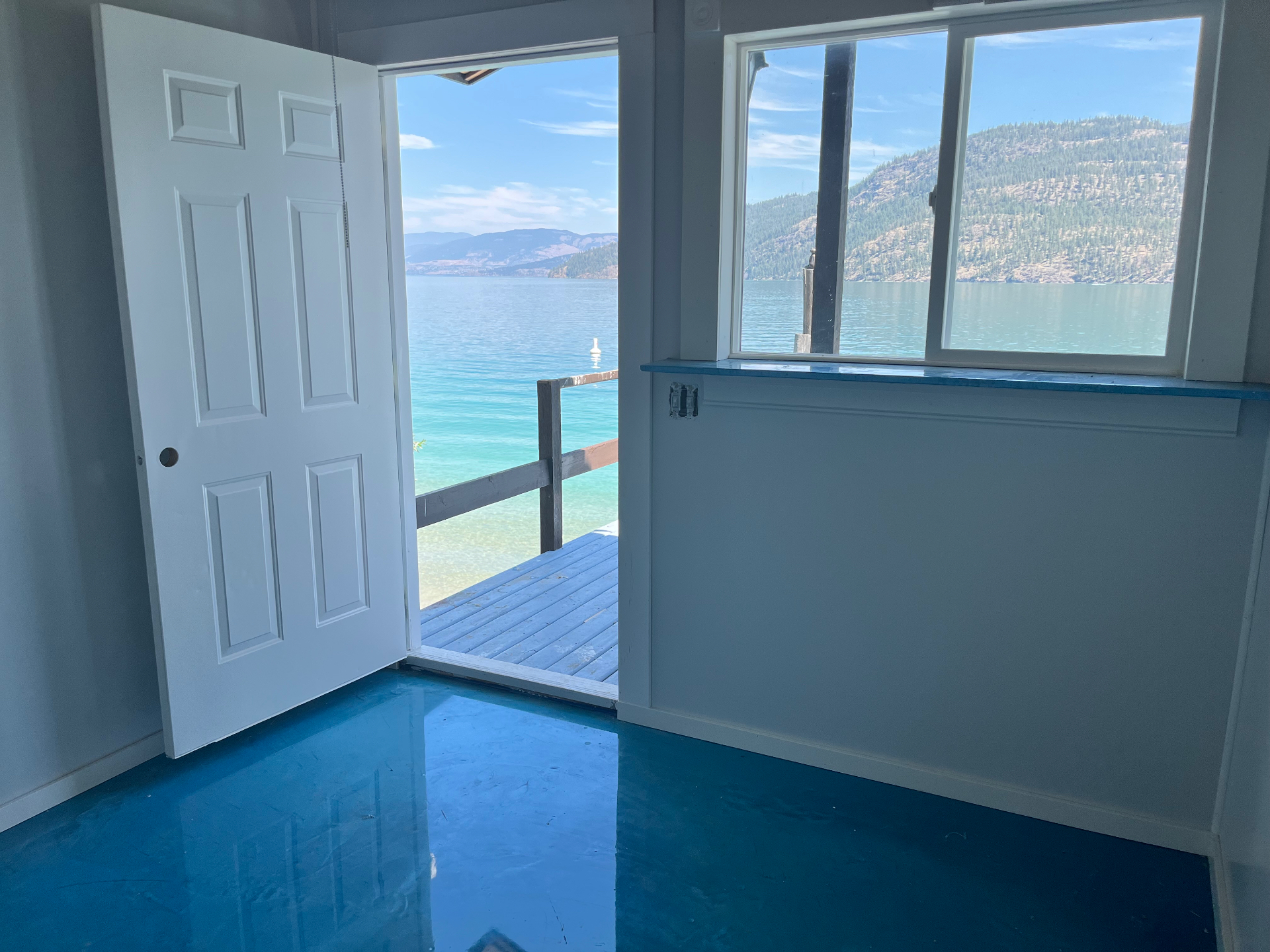 The Kalamalka Glow treatment room, its door open to a private dock and the turquoise lake beyond